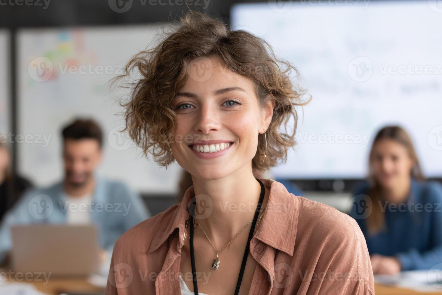 Close-up of a teacher smiling while explaining a concept during an online lesson. A whiteboard in the background highlights teaching tools, creating an interactive atmosphere for students photo