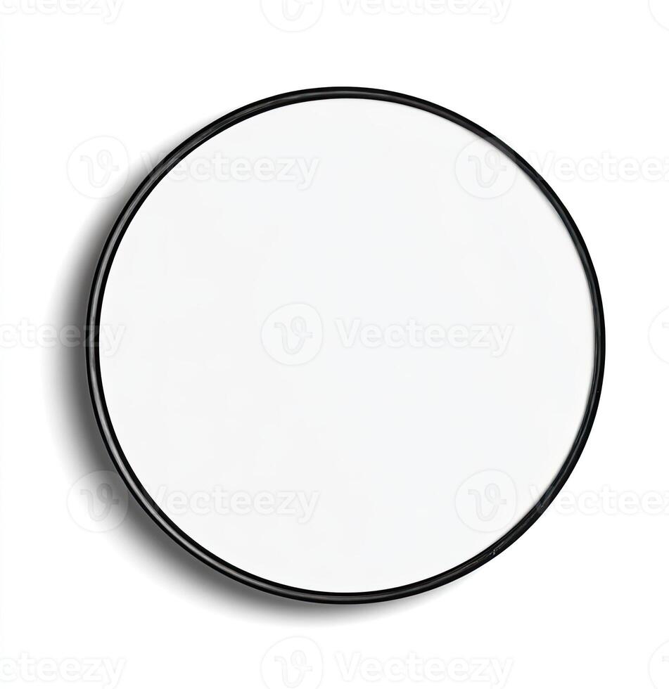 A round mirror with a black frame, set against a white backdrop, casting a subtle shadow photo