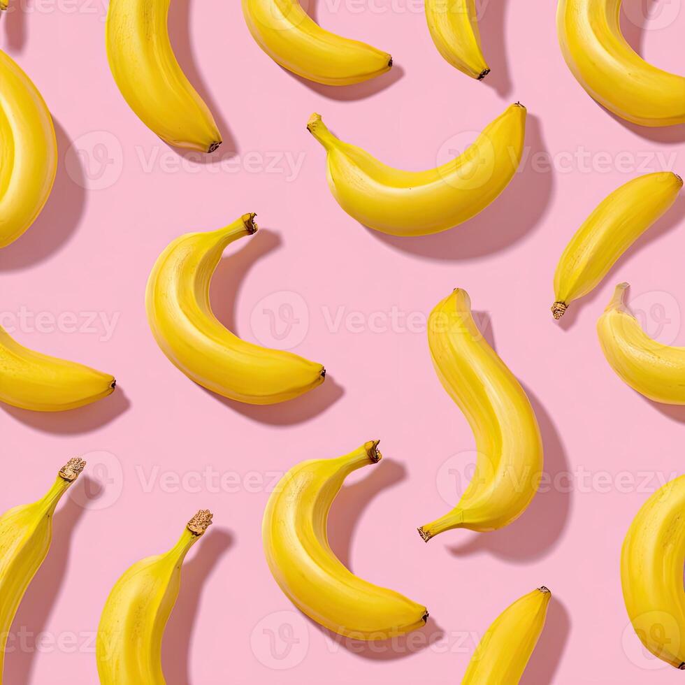 Overhead shot of ripe bananas scattered against a vibrant pink background, creating a pattern photo