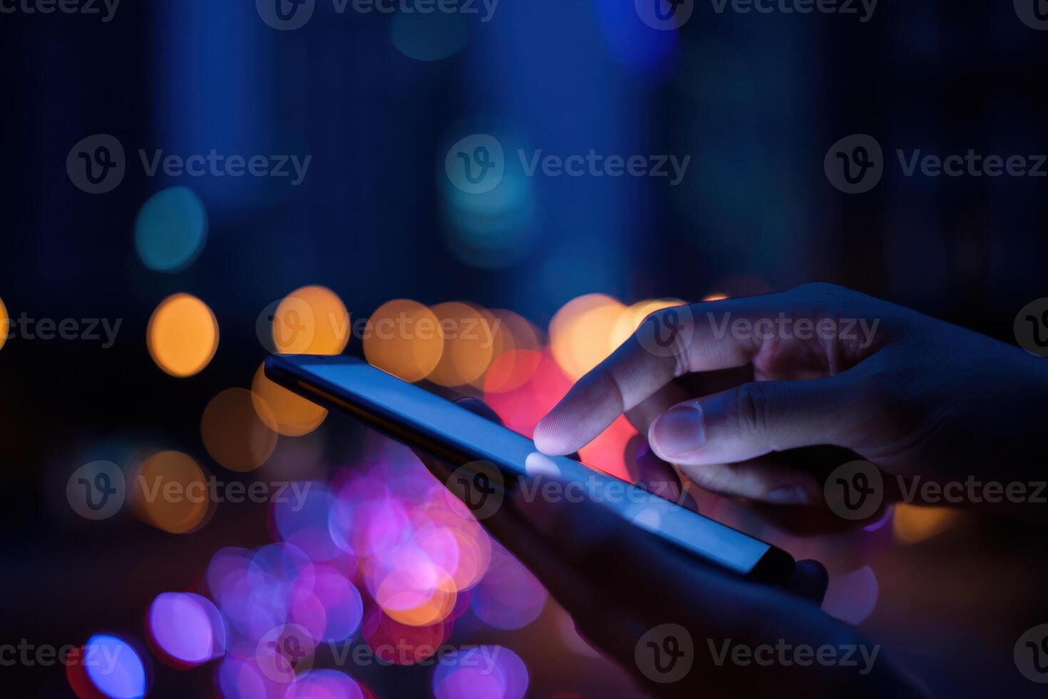 Point finger on screen phone close up, person testing test message, touch blue screen on smartphone. Night Bokeh Light. Close-UP. Person using in hands mobile phone close up in the dark. Online wi-fi photo