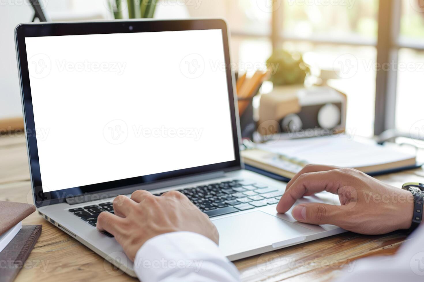 Man using laptop in office sitting at desk. Empty blank white screen mockup. Copy space area for text, logo, app. Person working, male hands typing. Mock up display PC. Business websites, services ads photo
