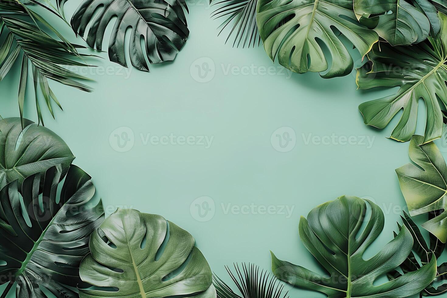 Tropical leaves frame. Green color tropics foliage on a blue solid background. Empty space in the center for product presentation. Flat lay, top view, copy space. Summer concept, minimalists style photo