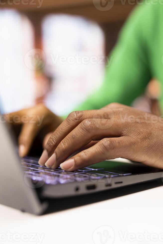 Teleworker in home office typing on laptop keyboard, preparing presentation slides, adjusting layouts. Close up of freelancer finishing company project, writing summaries, saving files on notebook photo