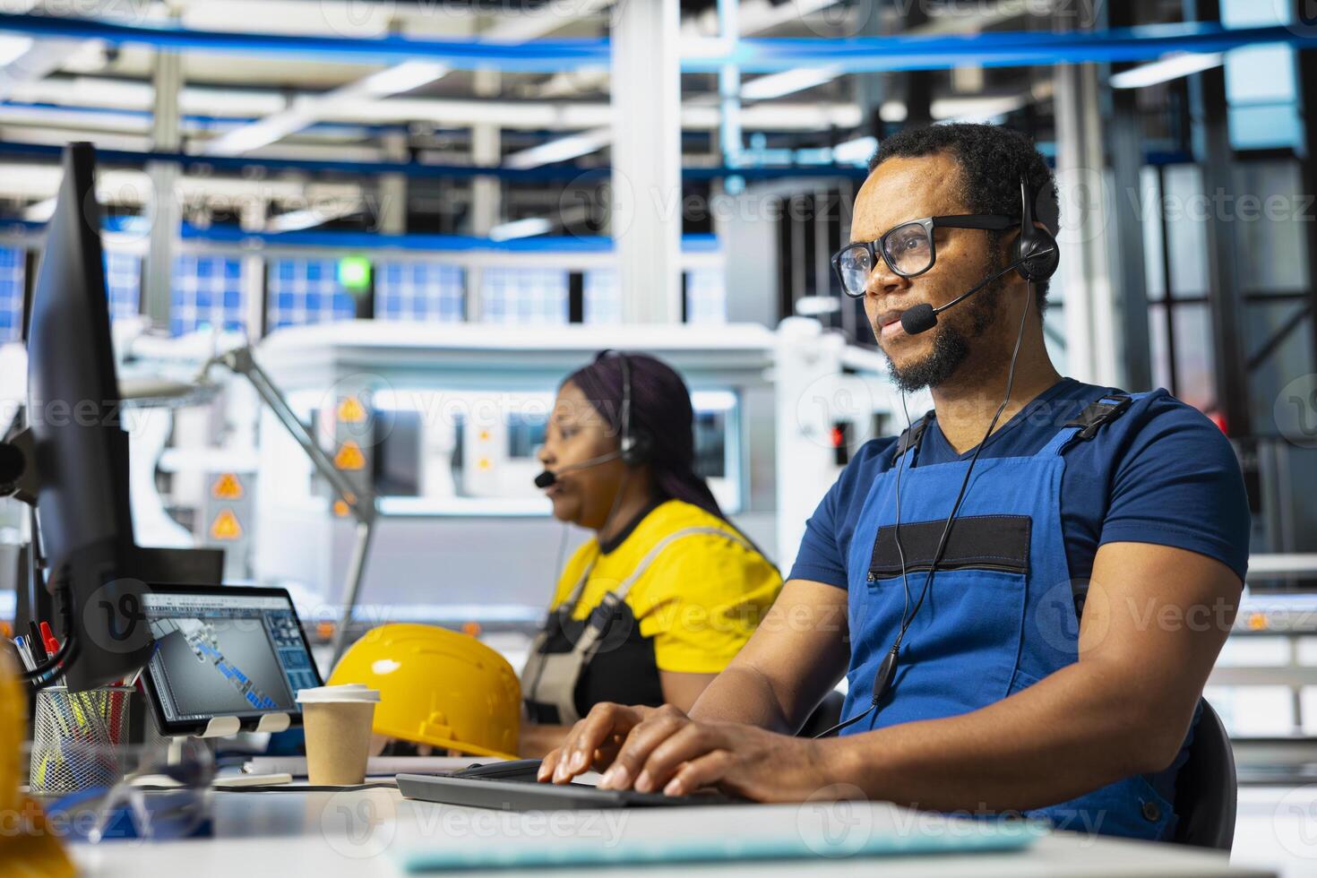 Customer service black assistant on helpline in solar panel factory answering calls on headset, providing guidance and assistance in fixing technical errors. Young help desk operator at plant. photo