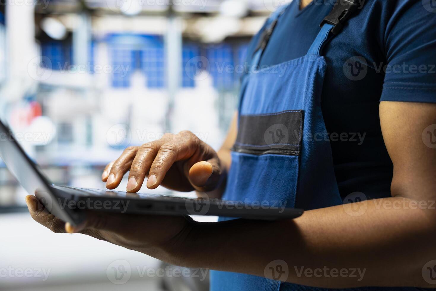 Male engineer works on solar energy software settings in high tech factory, optimizing the production process. Optimal system configuration with digital tools and industrial robotics. Close up. photo