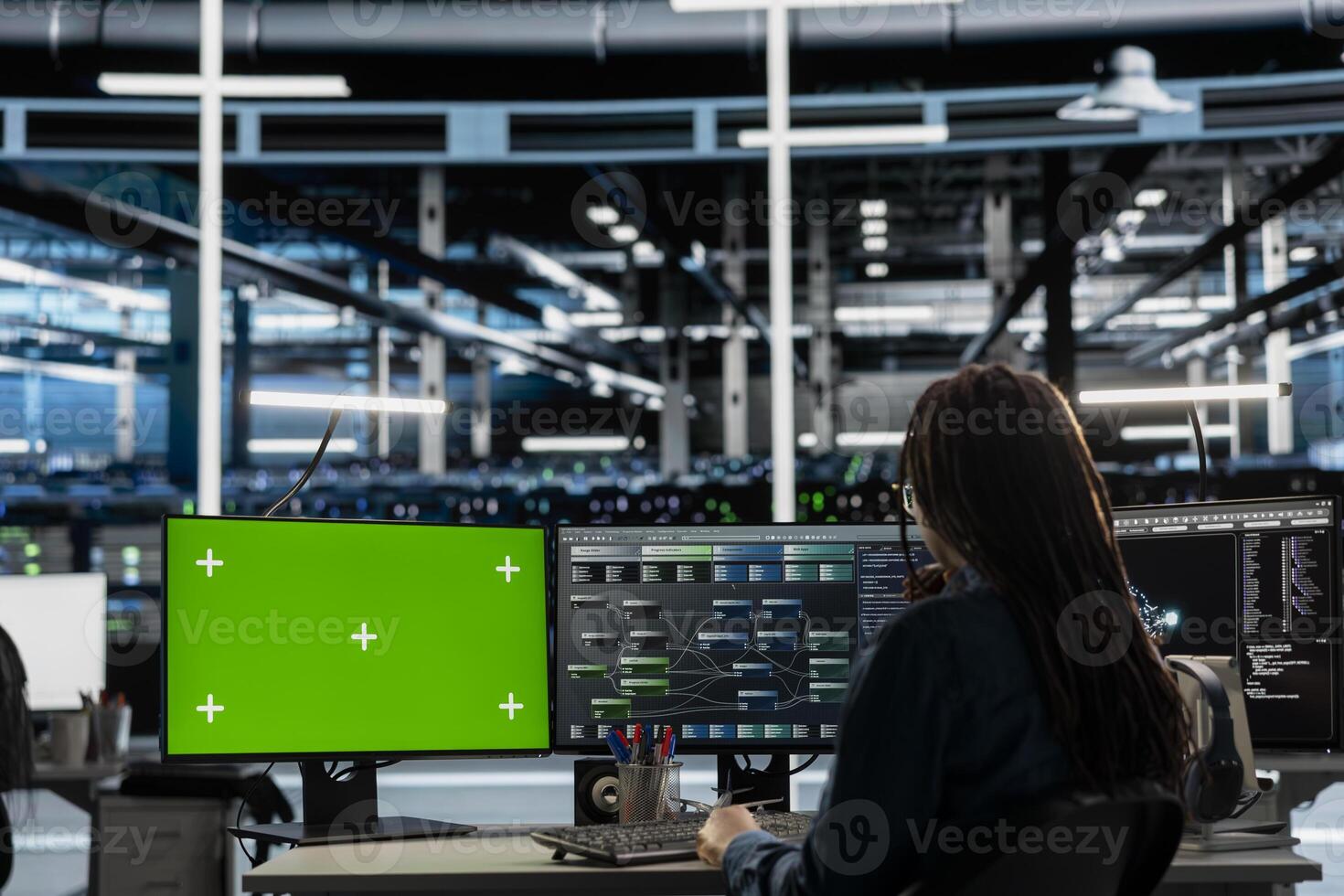 Engineer in data center using green screen computer to check equipment performance upgrading infrastructure. Worker doing maintenance on supercomputers in servers room using mockup PC photo
