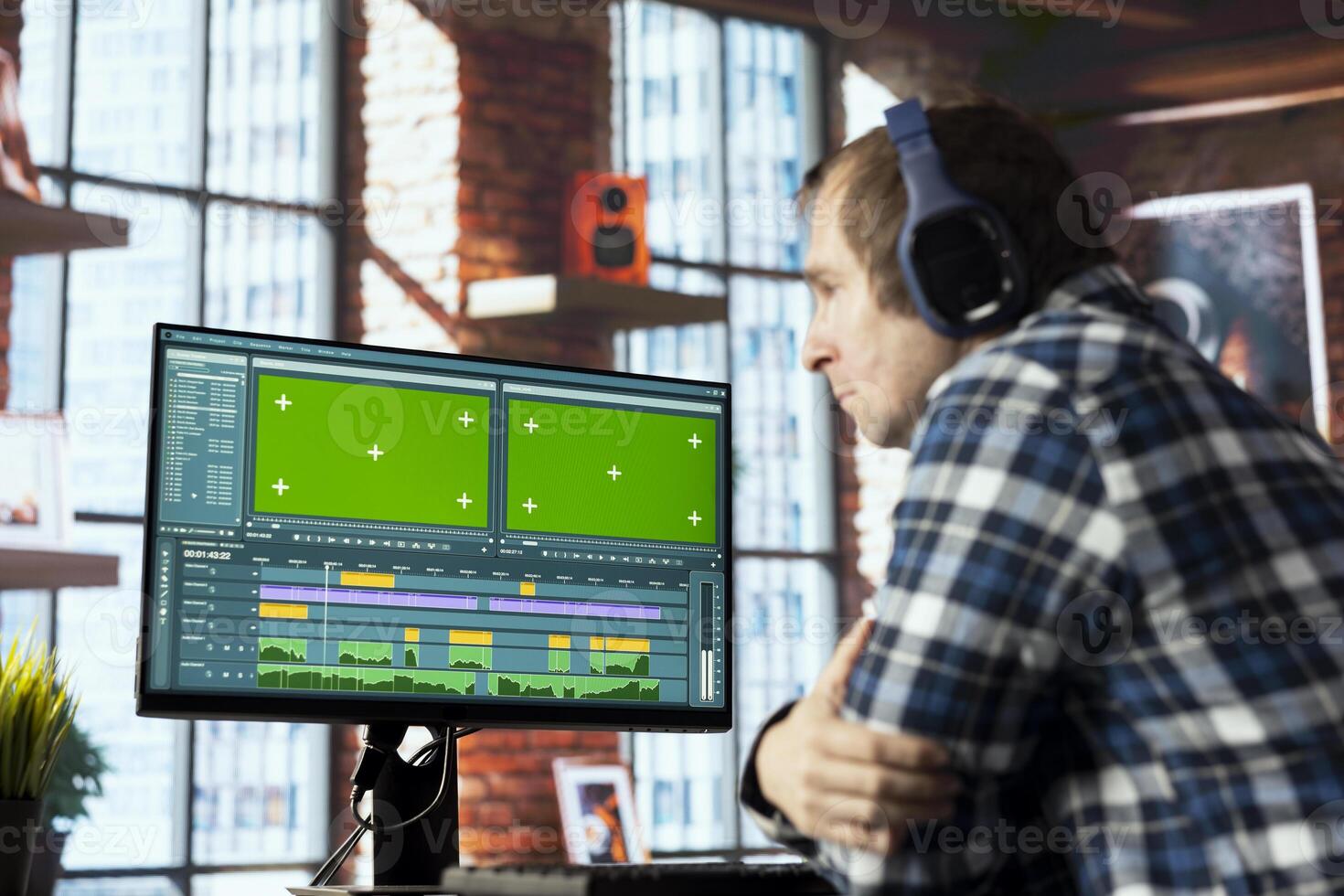 editor selecting key frames to use while doing montage, working from home on green screen computer. Man using mouse to edit movie project footage in apartment office on mockup PC photo