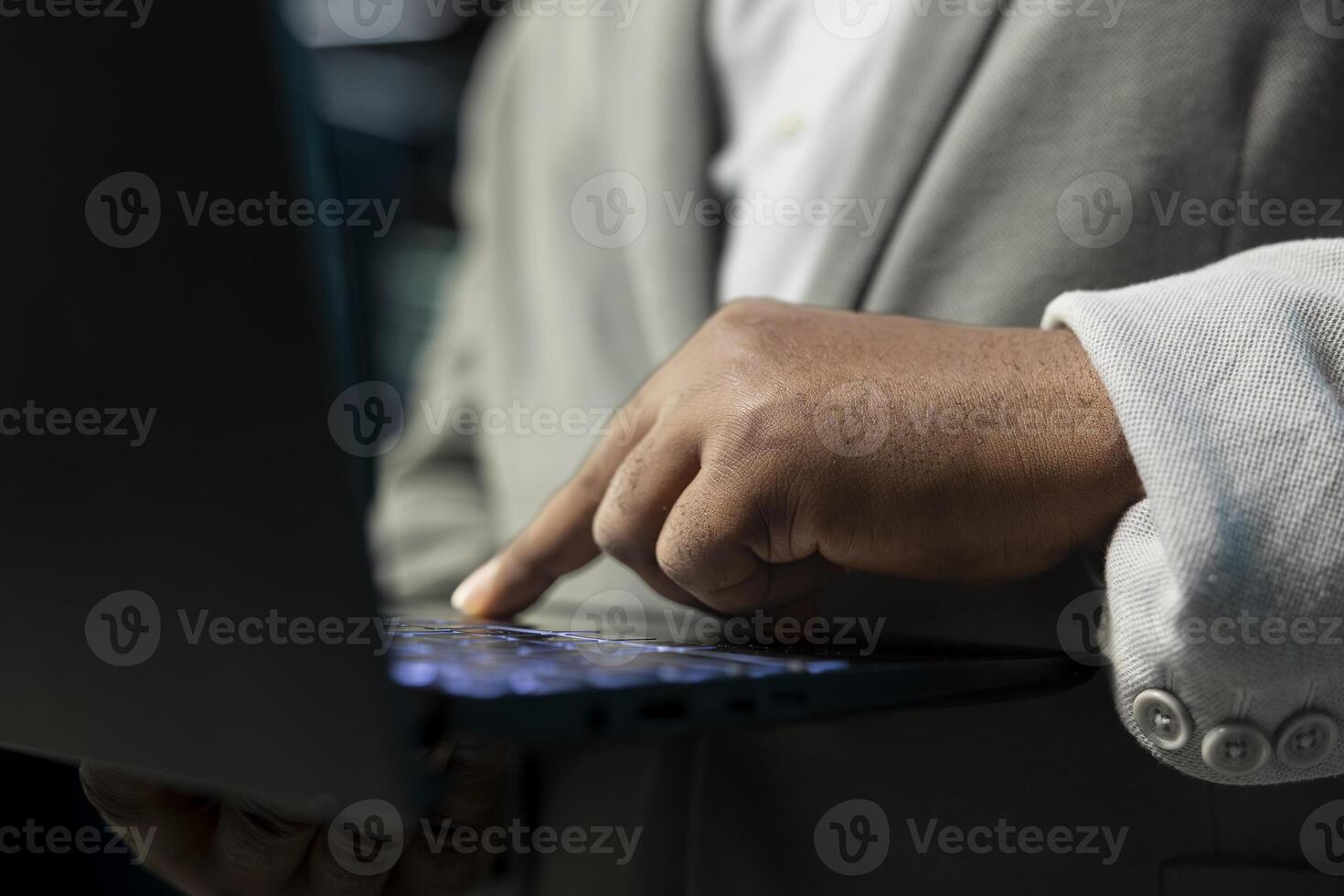 Close up of programmer in data center typing on notebook keyboard, writing lines of code. Server room IT expert using programming scripts on laptop, running diagnostics on infrastructure photo