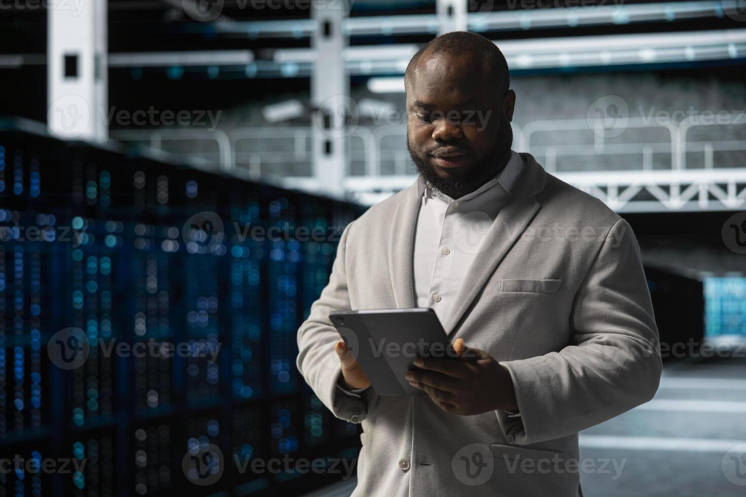 Data center employee fixing network issues affecting rigs performance, scripting automated workflows. Technician running system diagnostic tests, evaluating reports on tablet photo