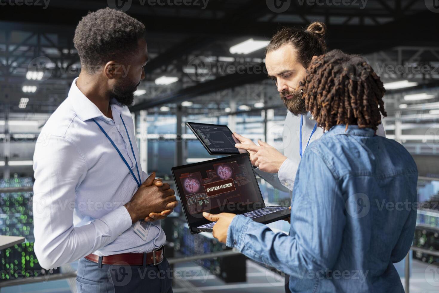 Multiethnic team worrying about compromised systems due to security breach, implementing emergency protocol to protect and save the server hub infrastructure. Malicious hacking danger. photo