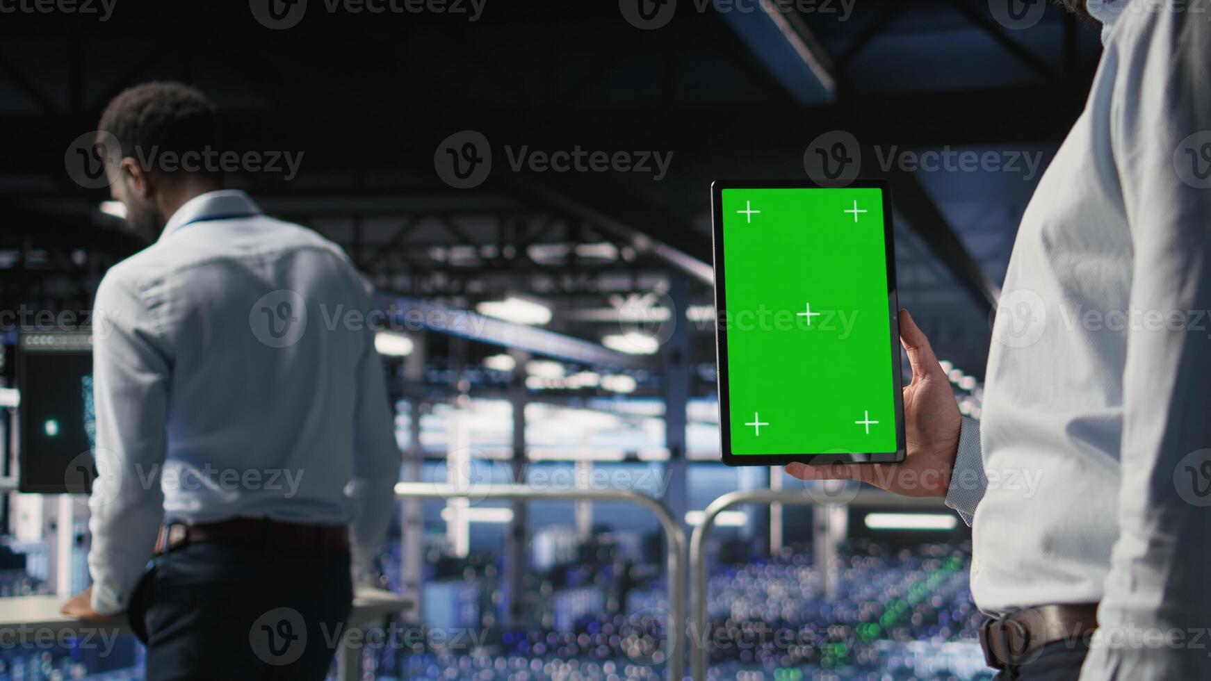 Close up of data center admin using mockup tablet to update storage arrays software, configuring network virtualization. Server room IT expert using chroma key device to verify settings, photo