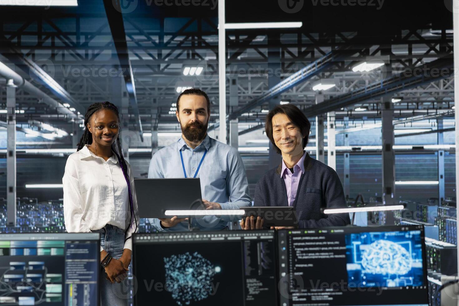 Portrait of smiling multiethnic engineers in data center troubleshooting server connectivity issues using AI. Upbeat multiracial technicians in diverse server room auditing systems for vulnerabilities photo
