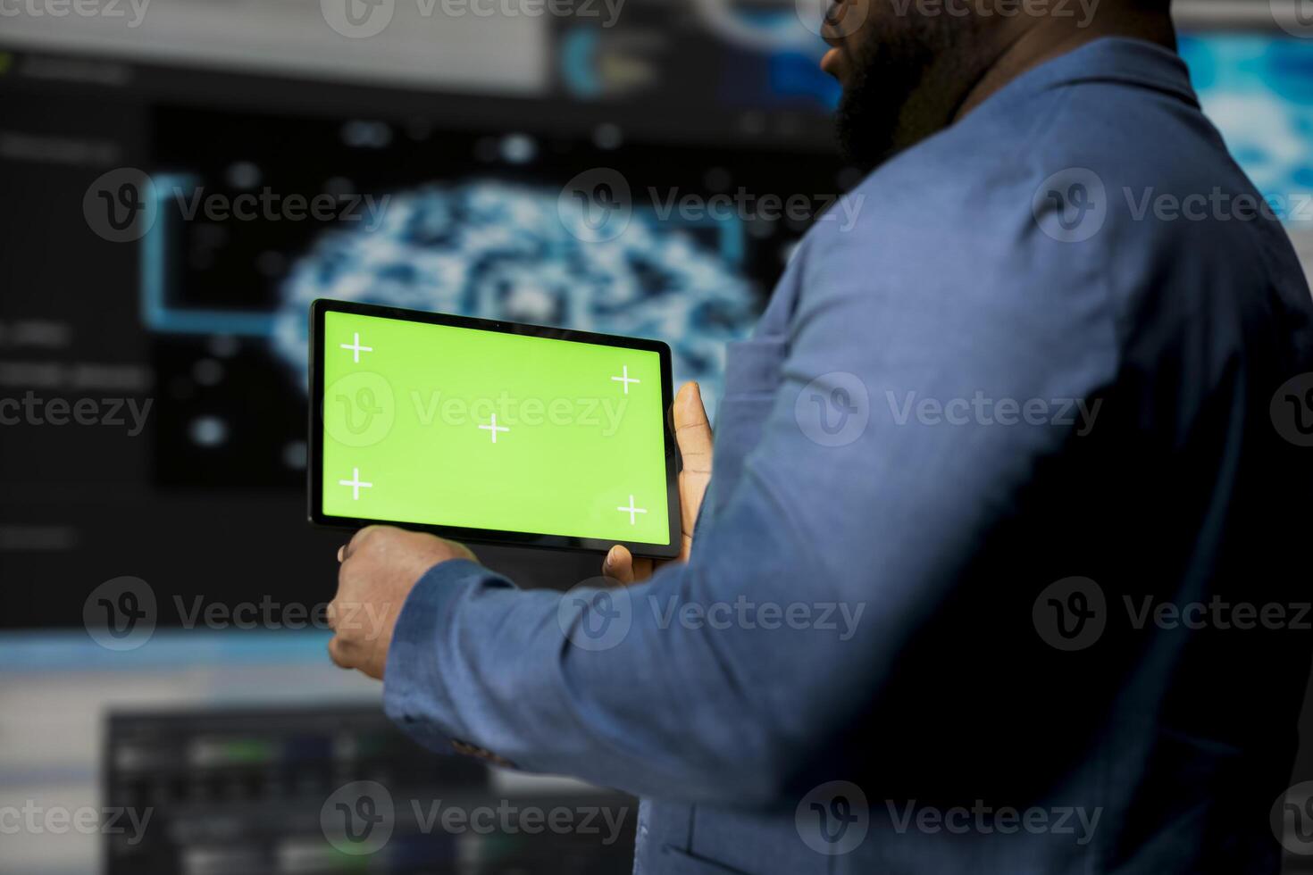 African American expert holds device with mockup screen with binary code in the background, digital transformation. Showcasing software development with algorithms, data science. photo
