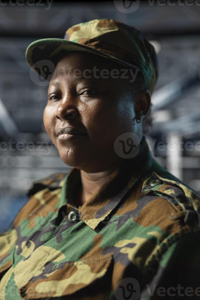 Close up of server hub employee in soldier uniform evaluating infrastructure resilience under enemy attacks. Army information technology specialist in data center testing classified defense software photo