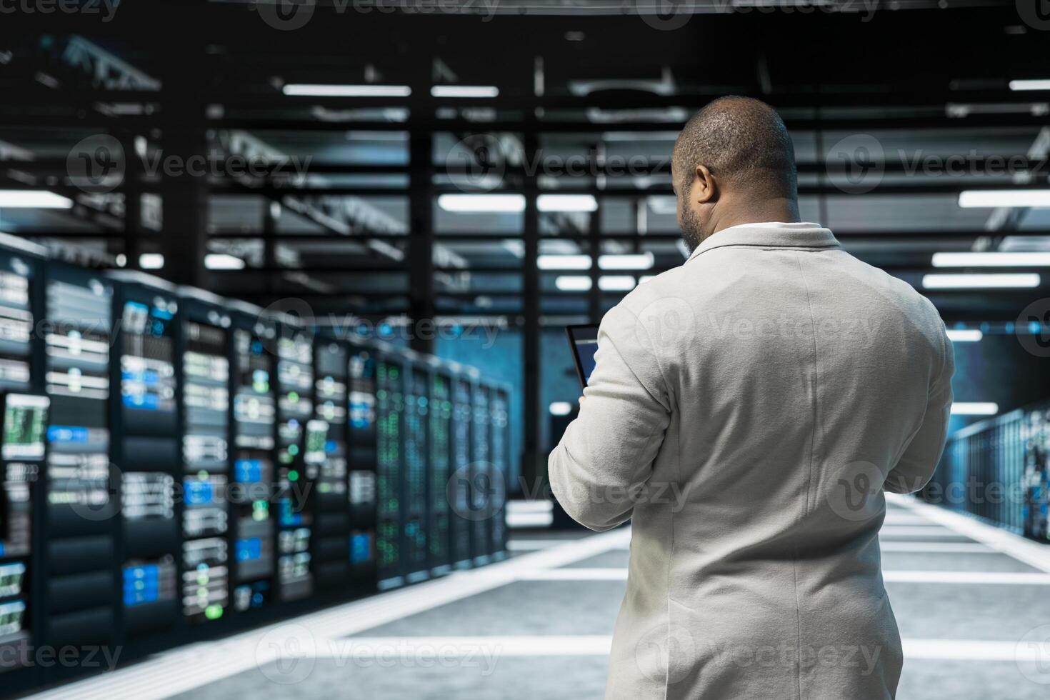 Admin in data center updating systems using tablet, conducting security audits to protect against cyber threats. Server hub IT specialist using device, deploying cybersecurity measures photo