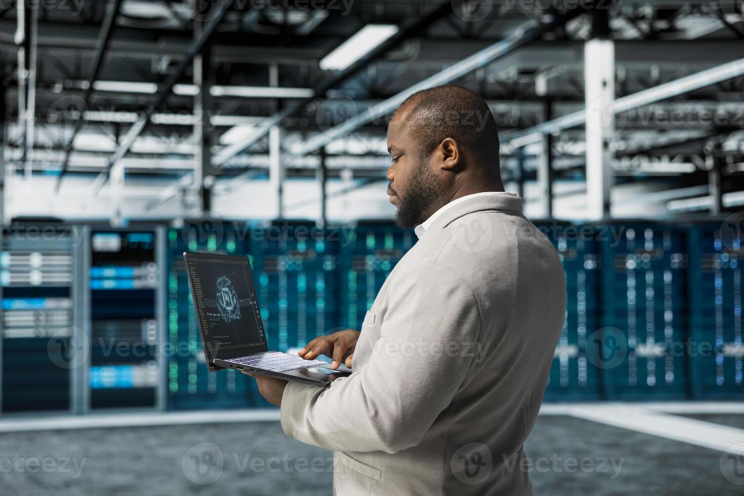 Data center engineer using artificial intelligence automation tools on laptop to increase uptime. Server hub worker working with AI machine learning to accelerate complex AI calculations photo