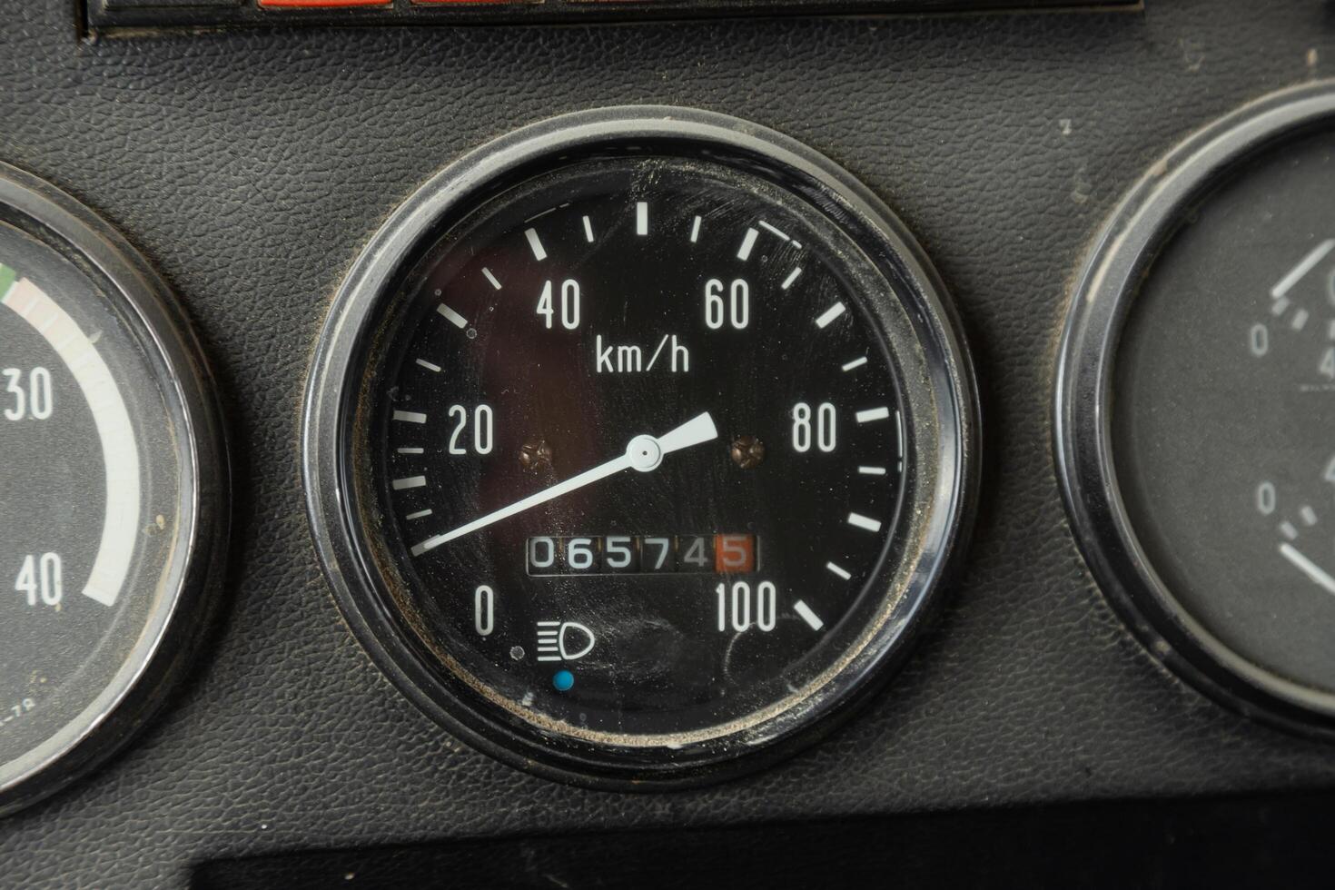 Old car speedometer. Speed indicator background. Parked car zero speed texture. Dashboard of oldschool car. Roration engine speed arrow photo