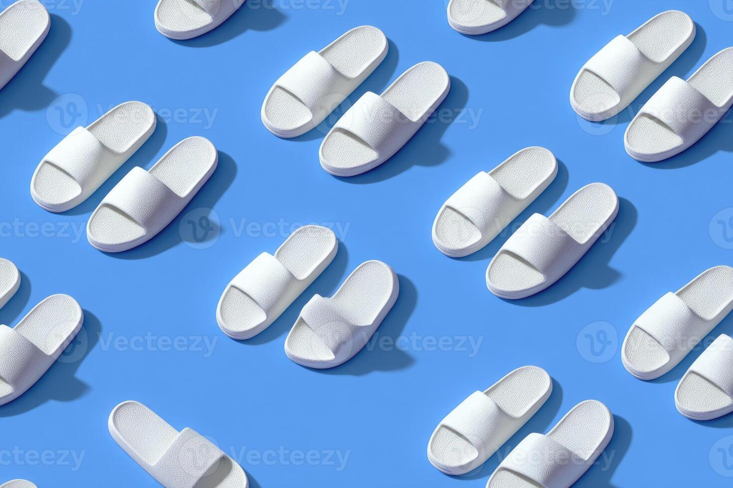 Overhead shot shows repeating pattern of white slides set against a bright blue background photo