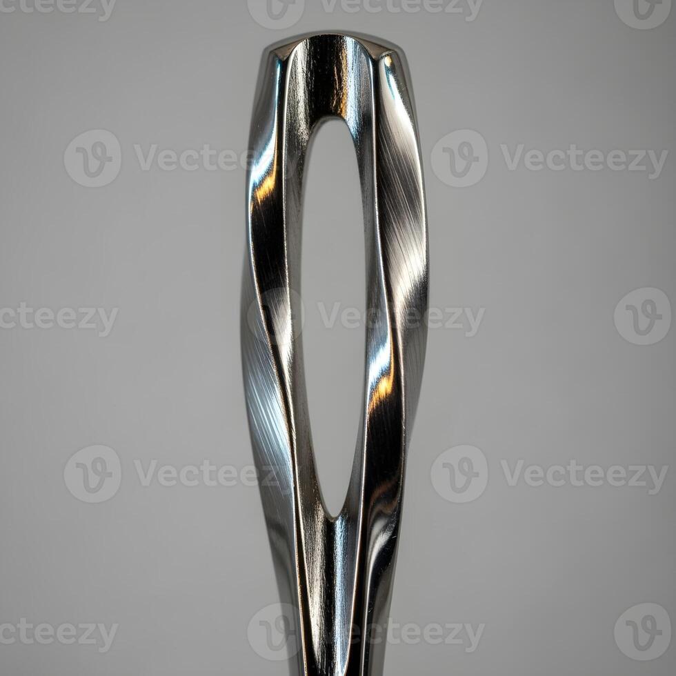 Macro Artistry Unveiling an Intriguing Twisted Needleloop with Sophisticated Metallic Textures and Delicate Reflections Against a Minimalist, Neutral, Elegant Backdrop. photo