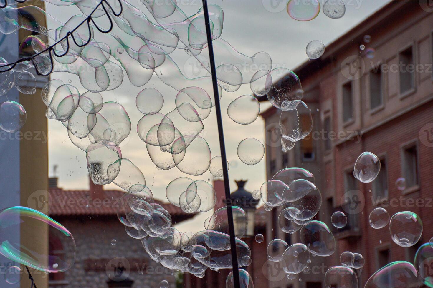 Hundreds of soap bubbles floating in the air, creating an ephemeral spectacle of colors and reflections photo