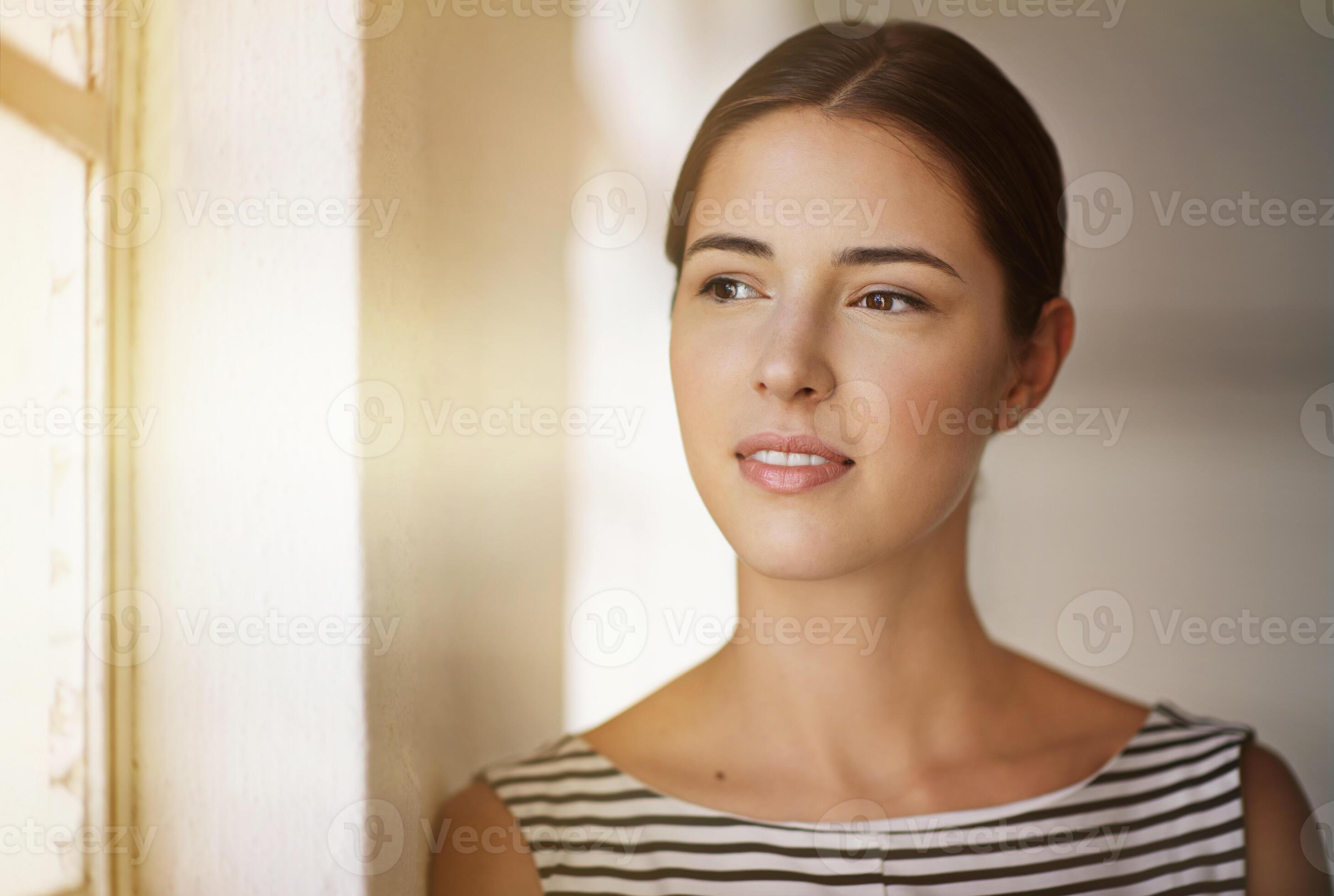 Woman reflecting and contemplating by window