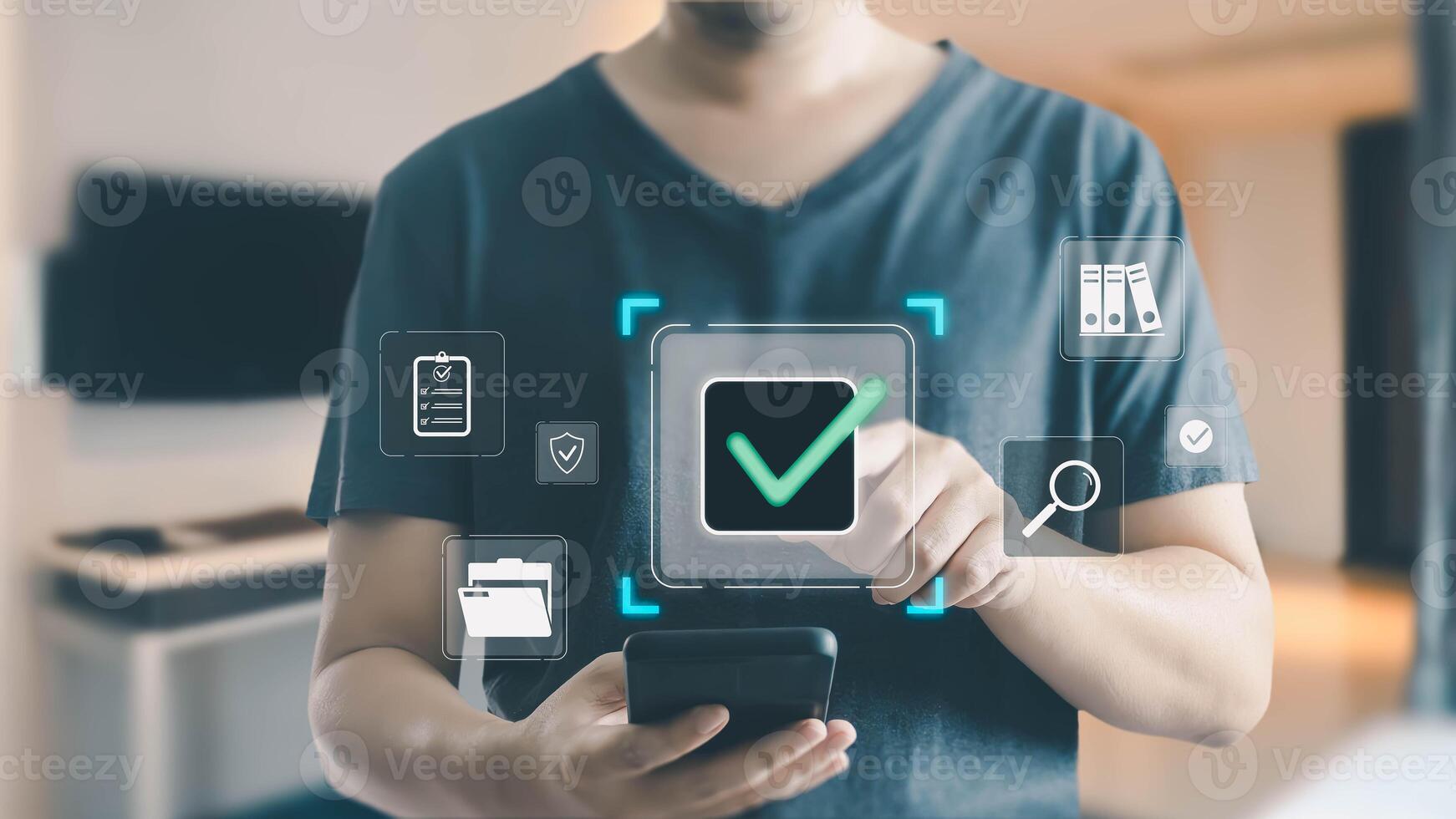 A man uses a smartphone to interact with a virtual interface, touching a large green checkmark icon for approval among various digital document management system icons. photo