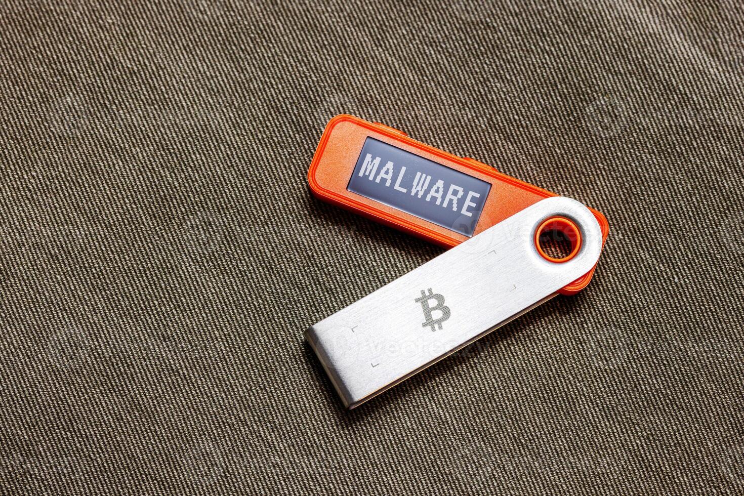 hardware Bitcoin wallet in with Malware message on screen photo