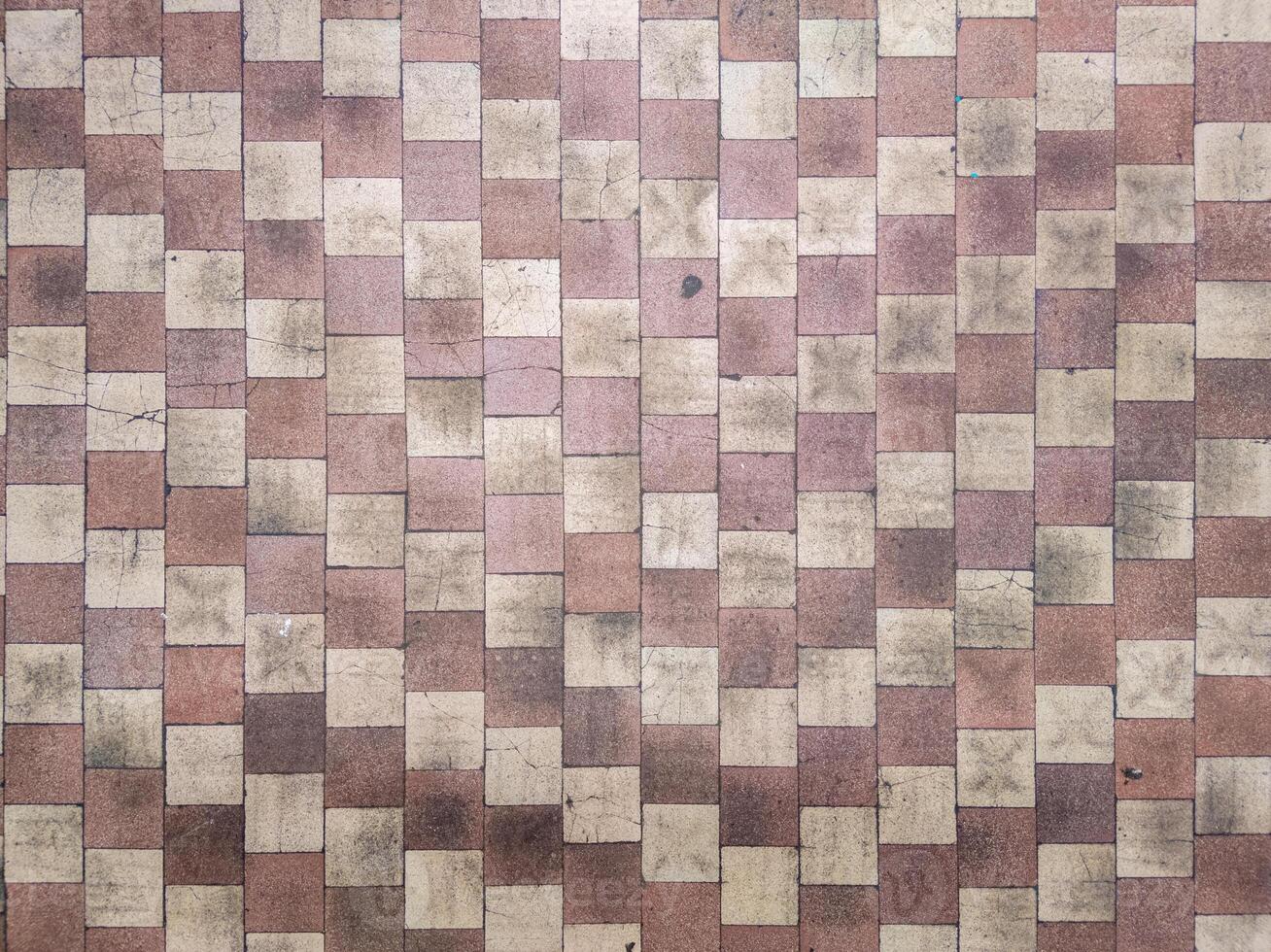 Worn checkerboard soviet tile floor in factory locker room - full-frame flat background and texture photo
