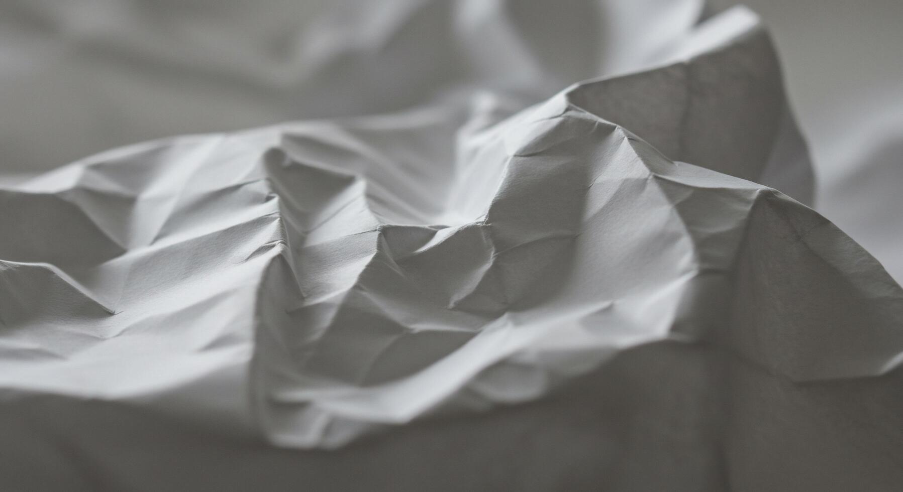 Abstract crumpled paper texture with soft shadows and subtle light play photo