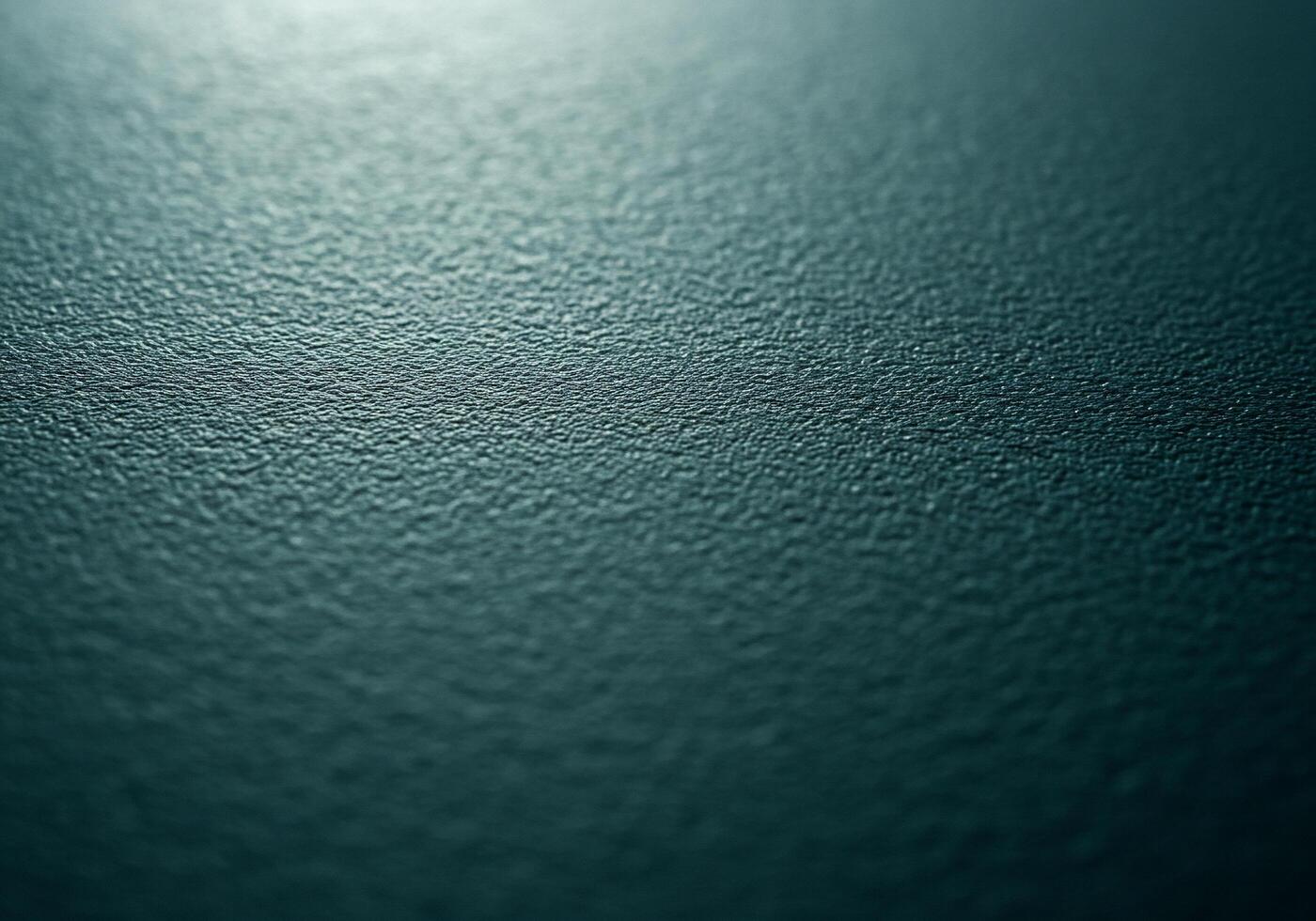 Textured teal surface with subtle light creating a calming and abstract background photo