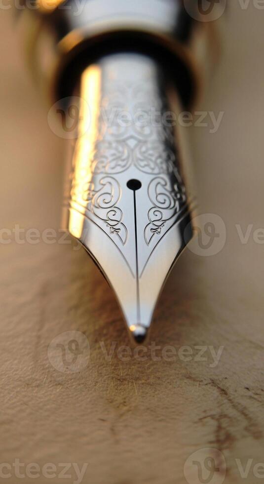Close up macro shot of a gleaming silver fountain pen nib with intricate engraved patterns resting on aged paper photo