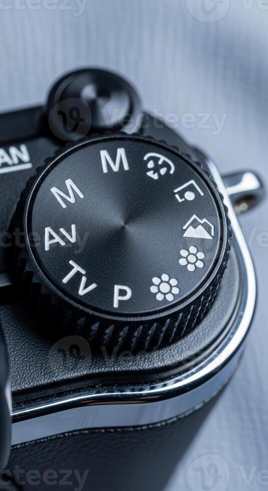 Close up of a digital camera mode dial showing manual aperture priority shutter priority and program settings photo