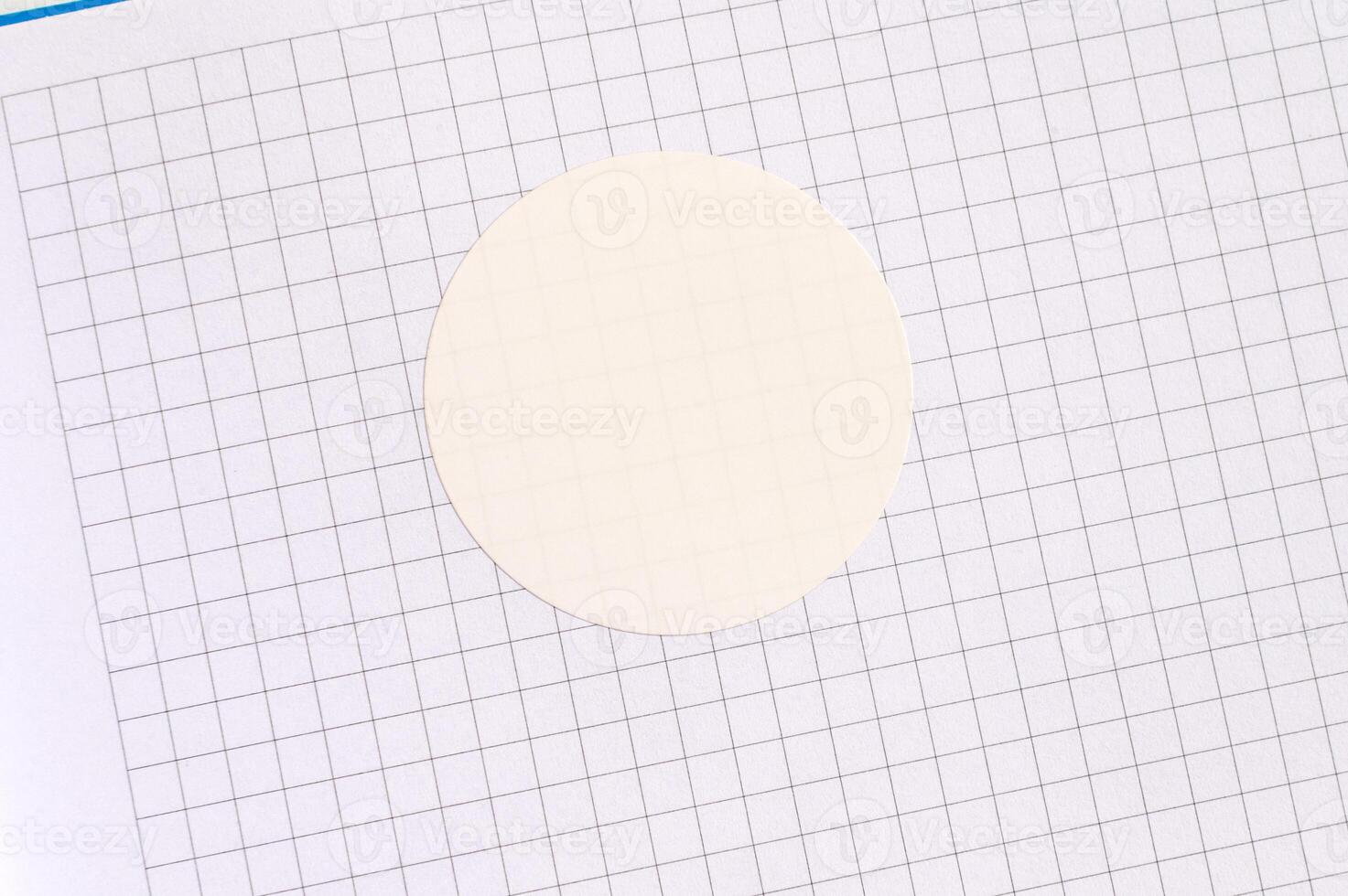 Blank circle sticker on graph paper with gridded background for design and craft use photo