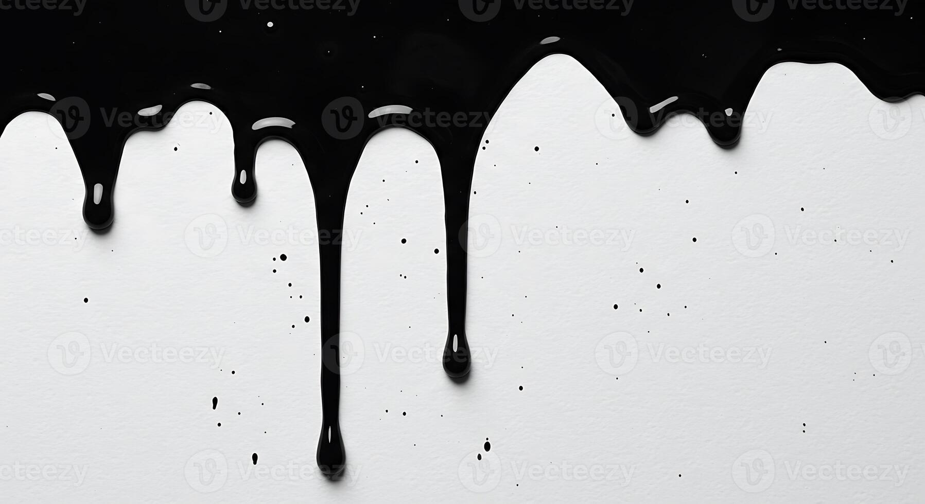 Black paint dripping down a white surface, creating an abstract pattern. photo