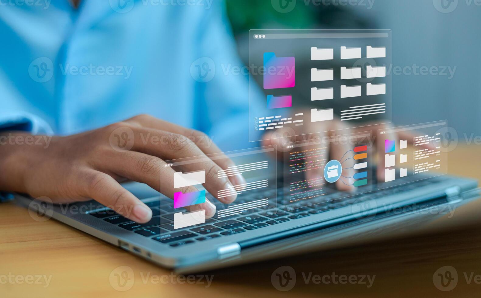 Hands typing on laptop with digital file folders interface, cloud computing and data management concept photo