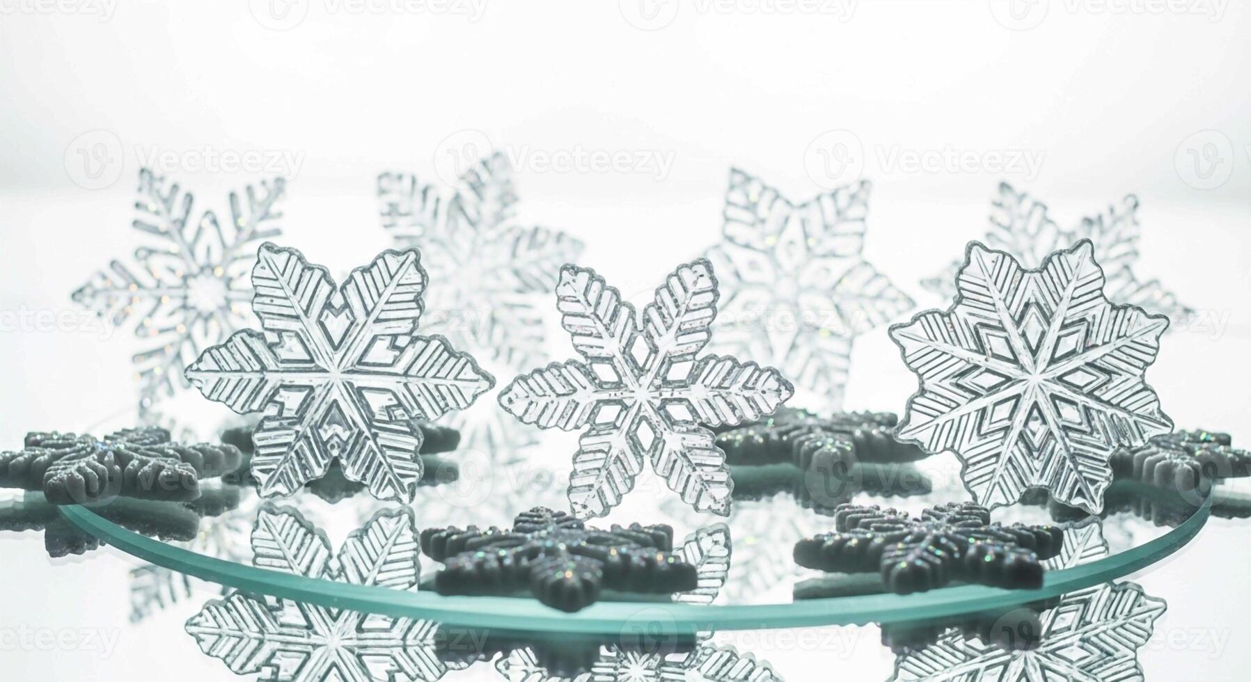 Sparkling frosted snowflake decorations arranged on a reflective surface creating a winter wonderland display photo