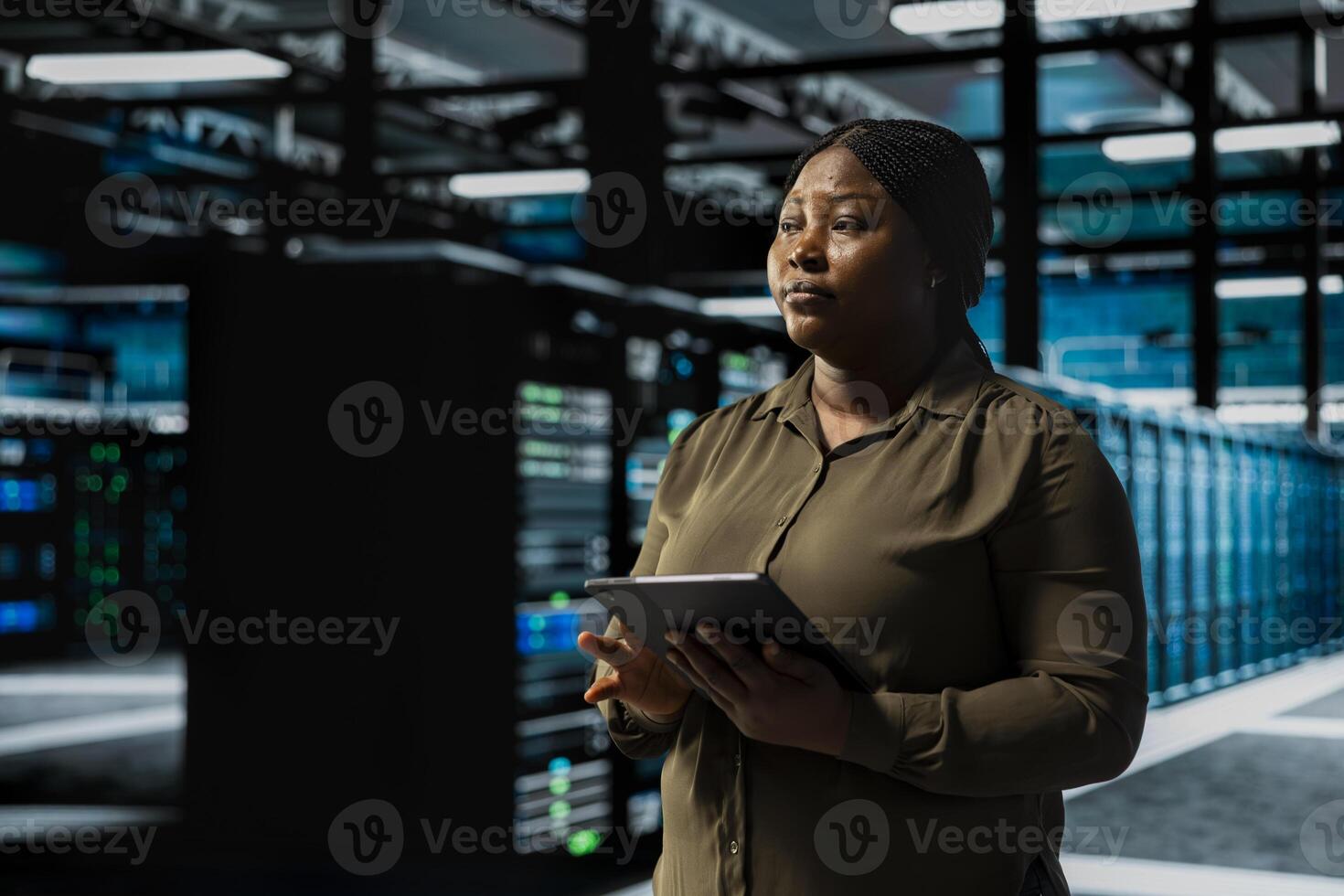 Data center system administrator conducting tests on equipment using software to fix bugs. Server room IT professional using tablet to refine algorithms for faster processing, updating core services photo