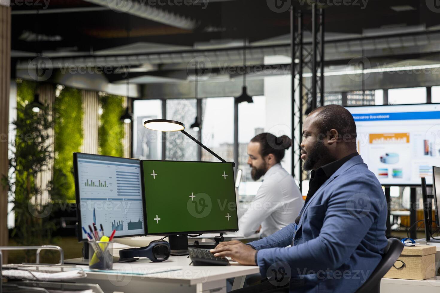 African american consultant focuses on business data next to copy space, working on general development within the corporate environment. Reviewing performance metrics for innovation. photo