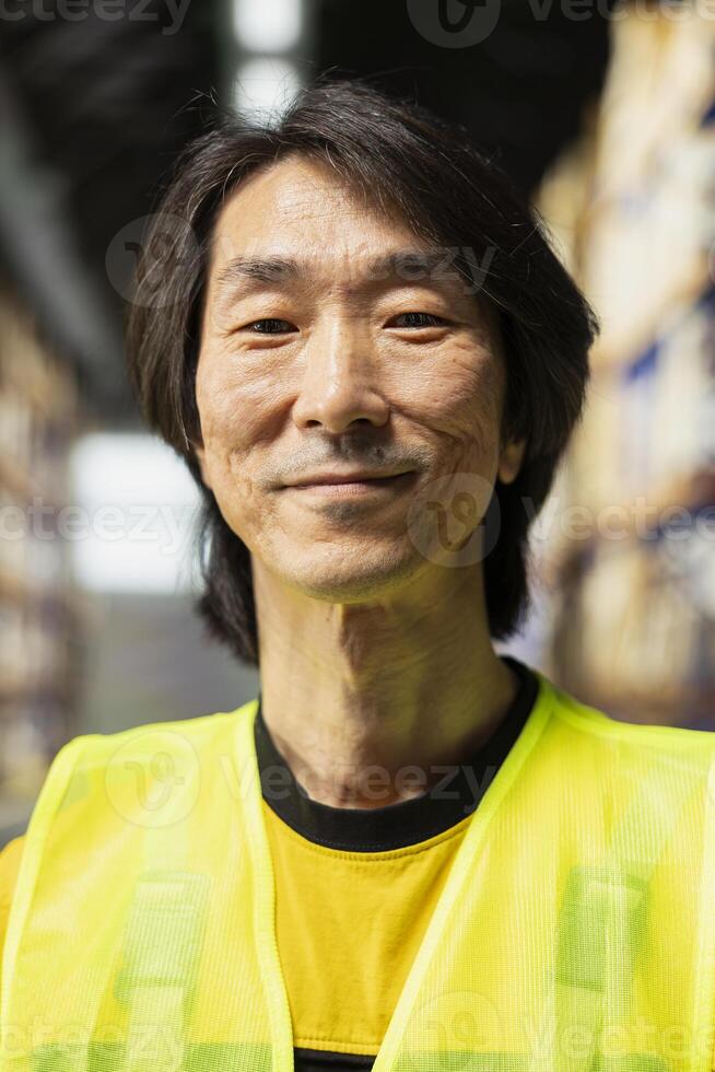 Asian business owner supervises order processing in a large scale logistics hub, coordinating express delivery and providing local customers with reliable service. Efficient e-commerce operations. photo