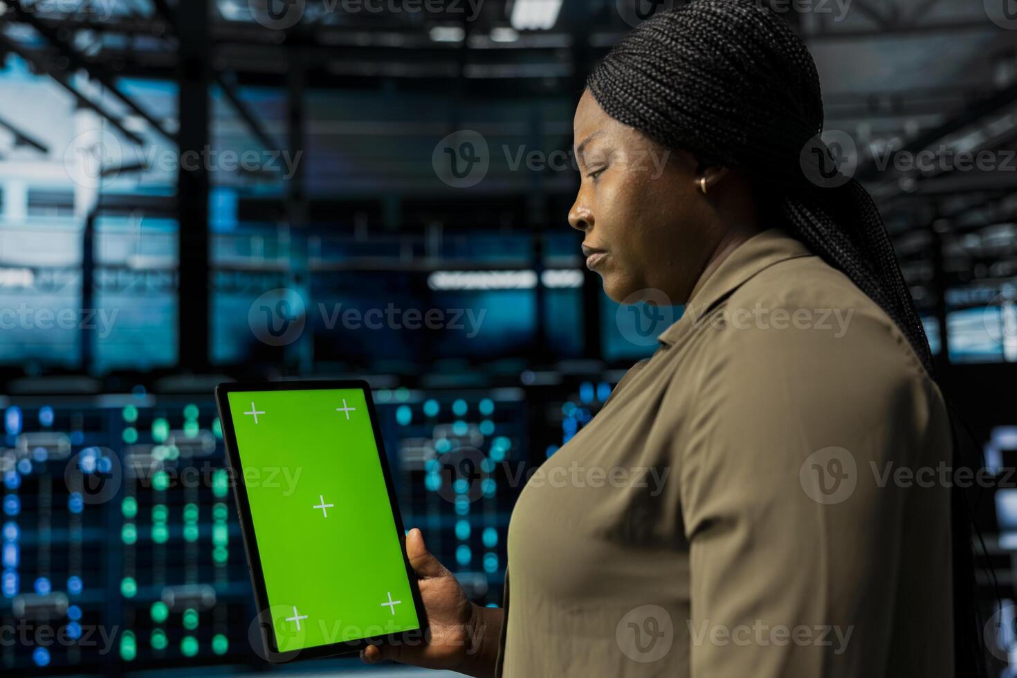 Manager uses isolated screen tablet to do checkup on data center electronics datasets. Server hub supervisor does backups on mockup device to protect gear used by cloud storage hosting companies photo