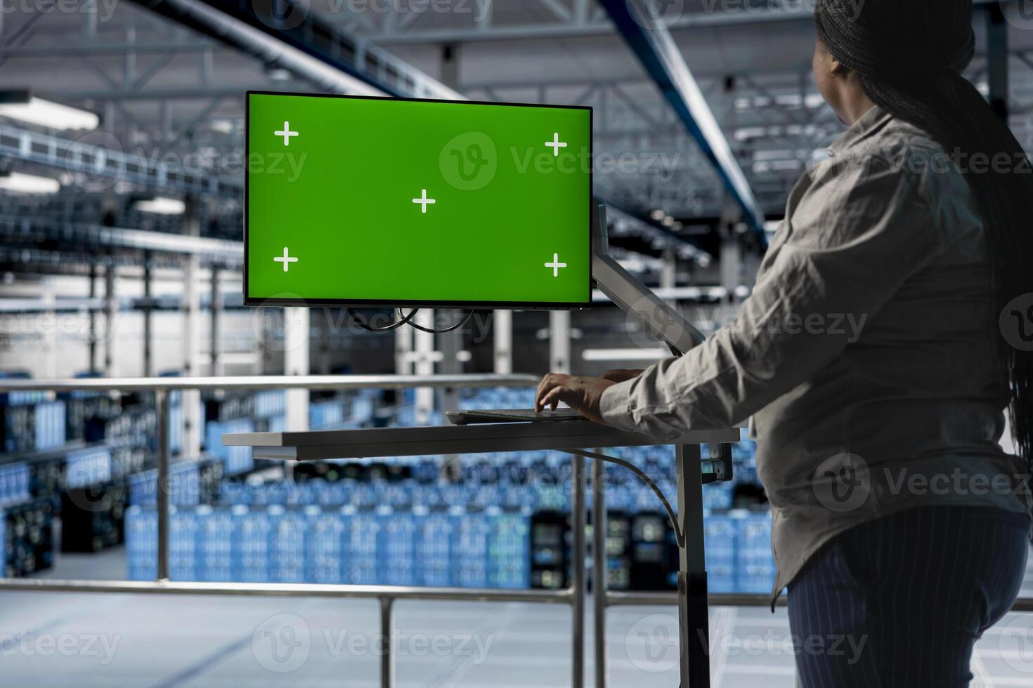 Server hub IT specialist uses mockup chroma key computer, implementing backup solutions. Data center programmer using green screen PC monitor, installing and upgrading server racks photo