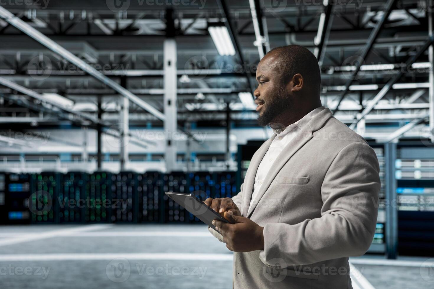 Data center admin updating systems to keeps performance up and protect servers from easily exploitable software vulnerabilities. Worker looking for errors causing servers to slow down photo