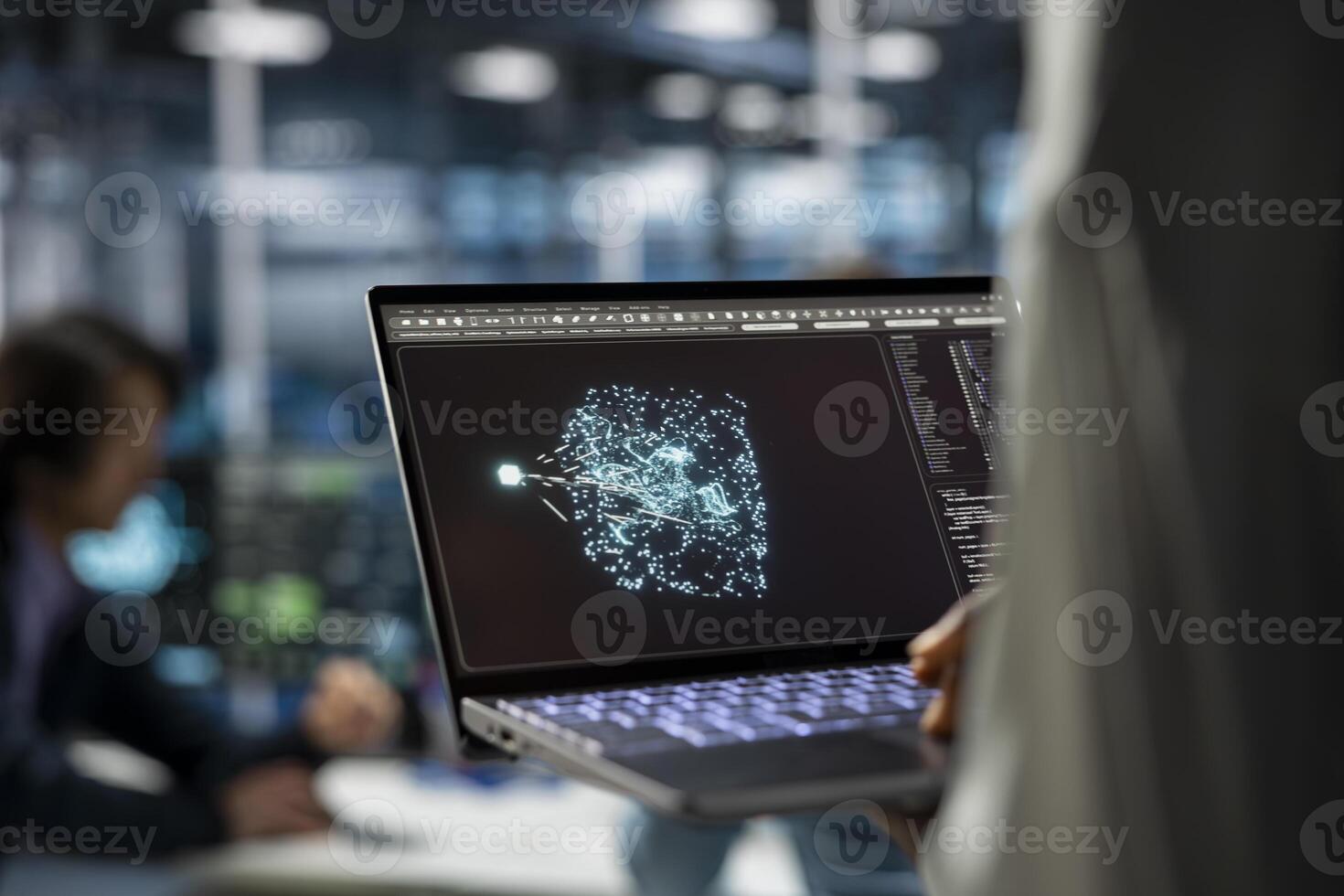 Close up of data center developer using laptop, working on databases supporting AI applications. IT professional uses notebook in server hub, doing algorithms improvements with artificial intelligence photo