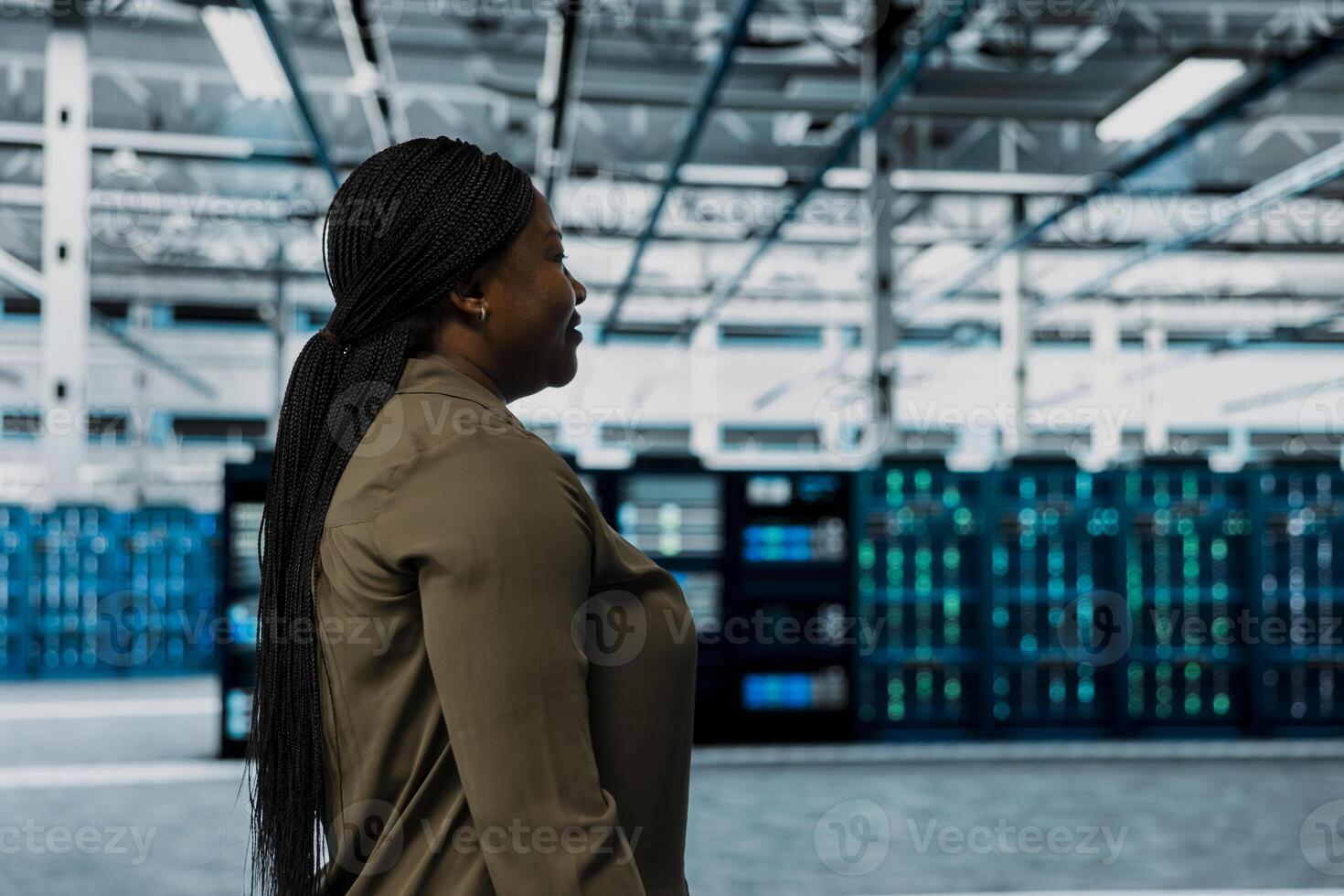 Technician walking through server room rows lined with storage infrastructure rigs. IT professional inspecting high tech data center helping power internet services for enterprise customers photo