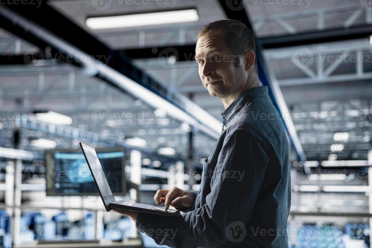 Cheerful server farm worker uses specialized hardware to accelerate complex AI calculations. Portrait of smiling engineer in data center providing computing resources and storage to enable AI training photo