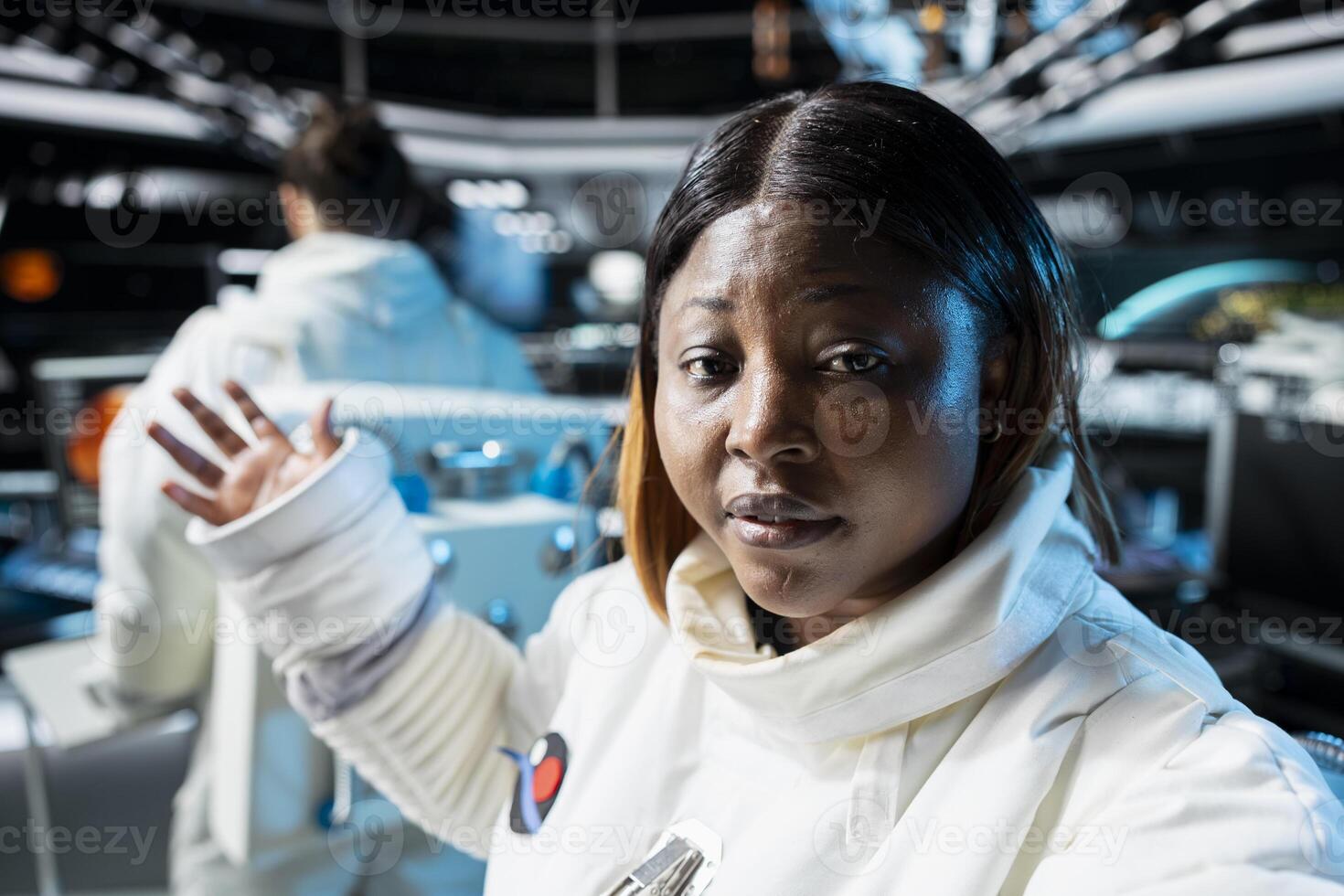 Astronaut doing personal log entry broadcasted from inside space station. Spaceship crew member sharing insights and updates during daily communication routine done for scientists on Earth photo