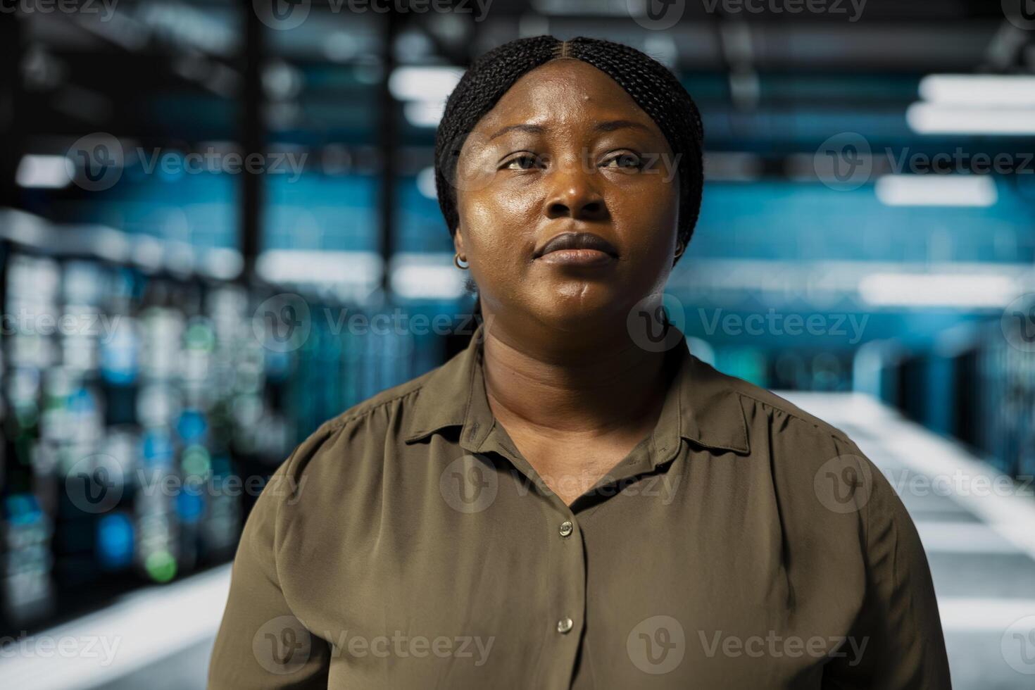 Close up of technician doing maintenance in data center with setup helping companies stay connected. African american worker walks in server farm with machines blinking lights showing system activity photo