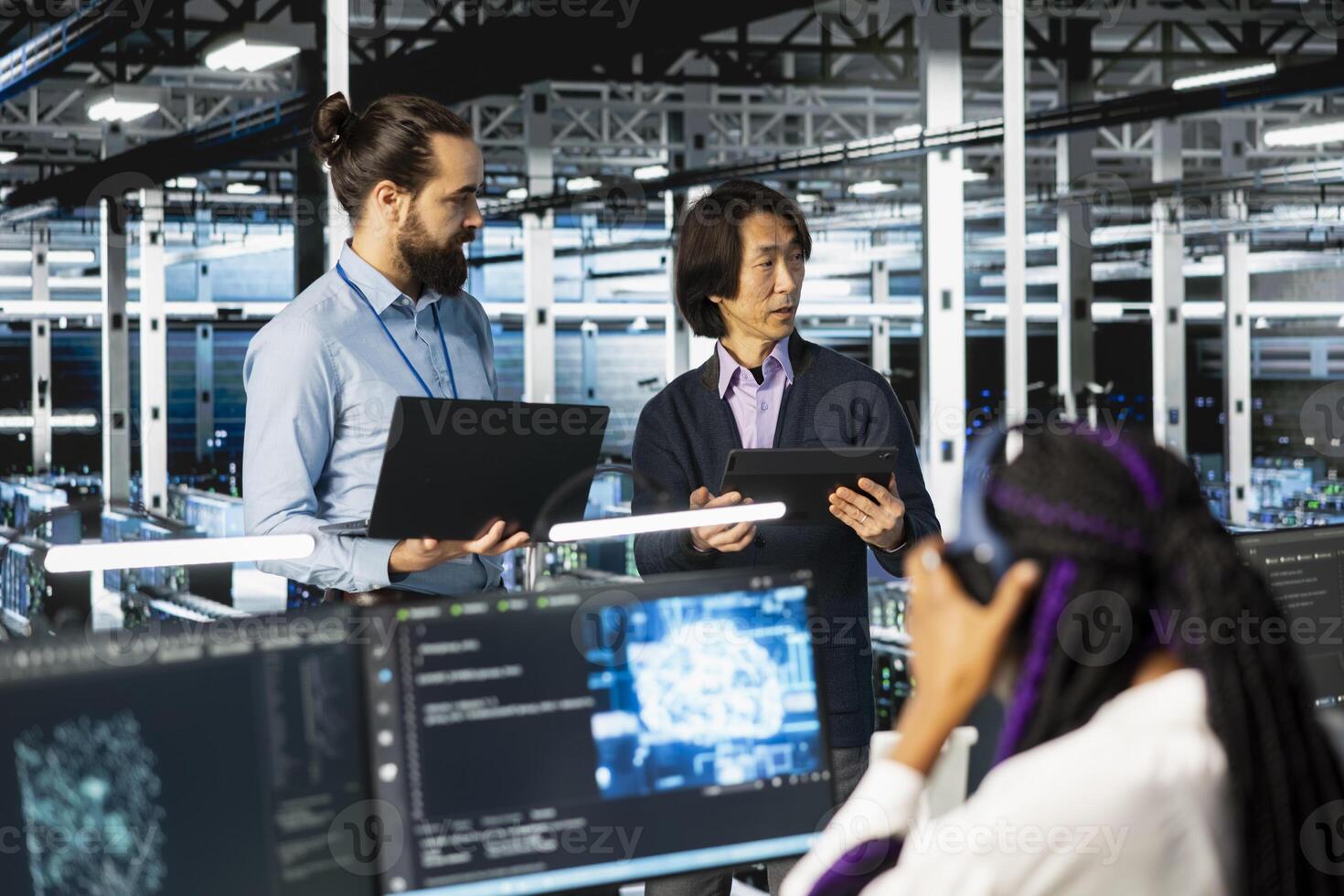 Multiethnic coworkers coding in diverse data center, updating AI automation scripts. Multiracial server room colleagues doing brainstorming, programming artificial intelligence algorithms photo