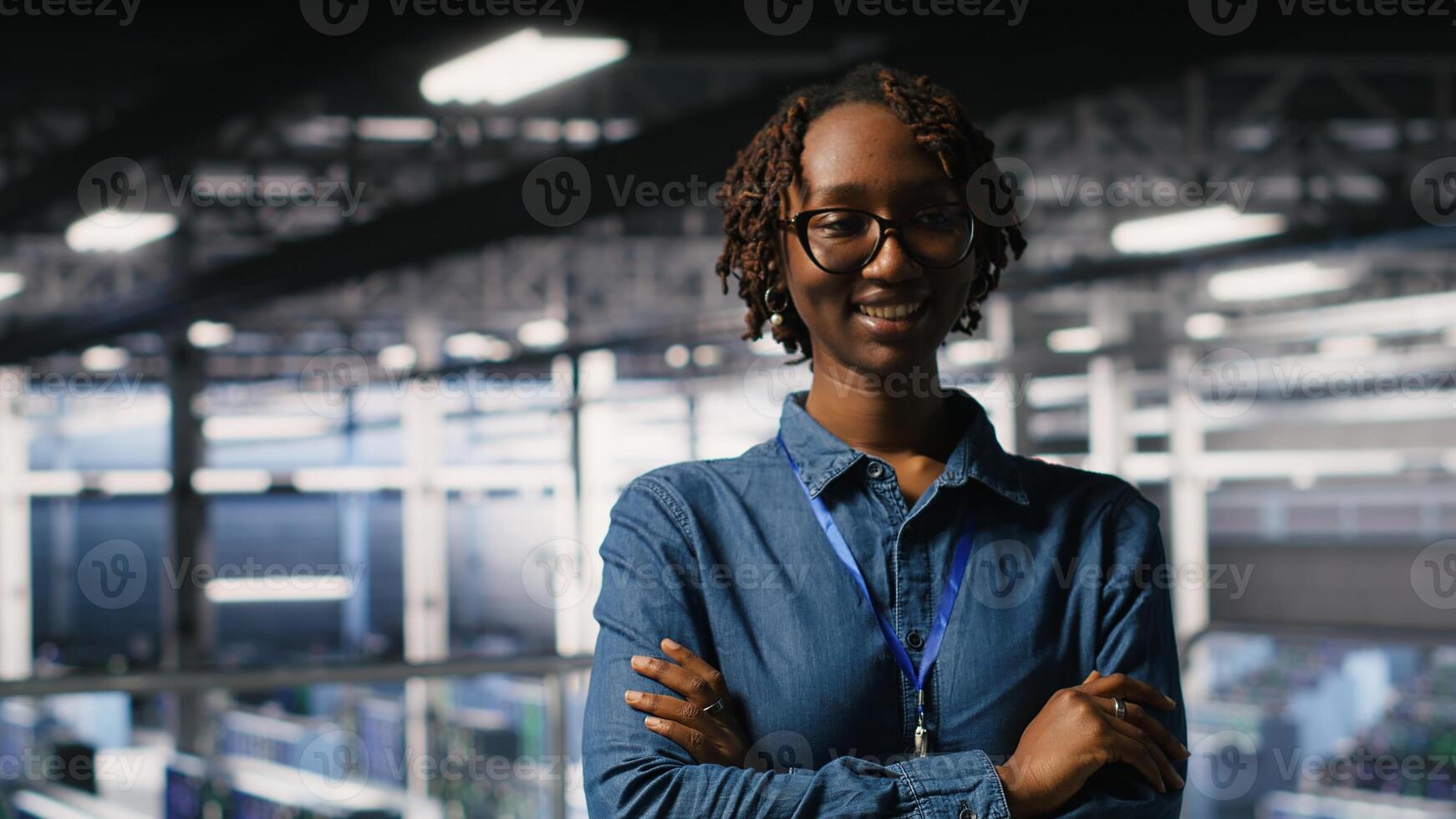 Portrait of smiling data center admin next to coworkers running diagnostics on equipment to identify errors. Happy woman next to IT experts working to prevent failure and minimize downtime photo