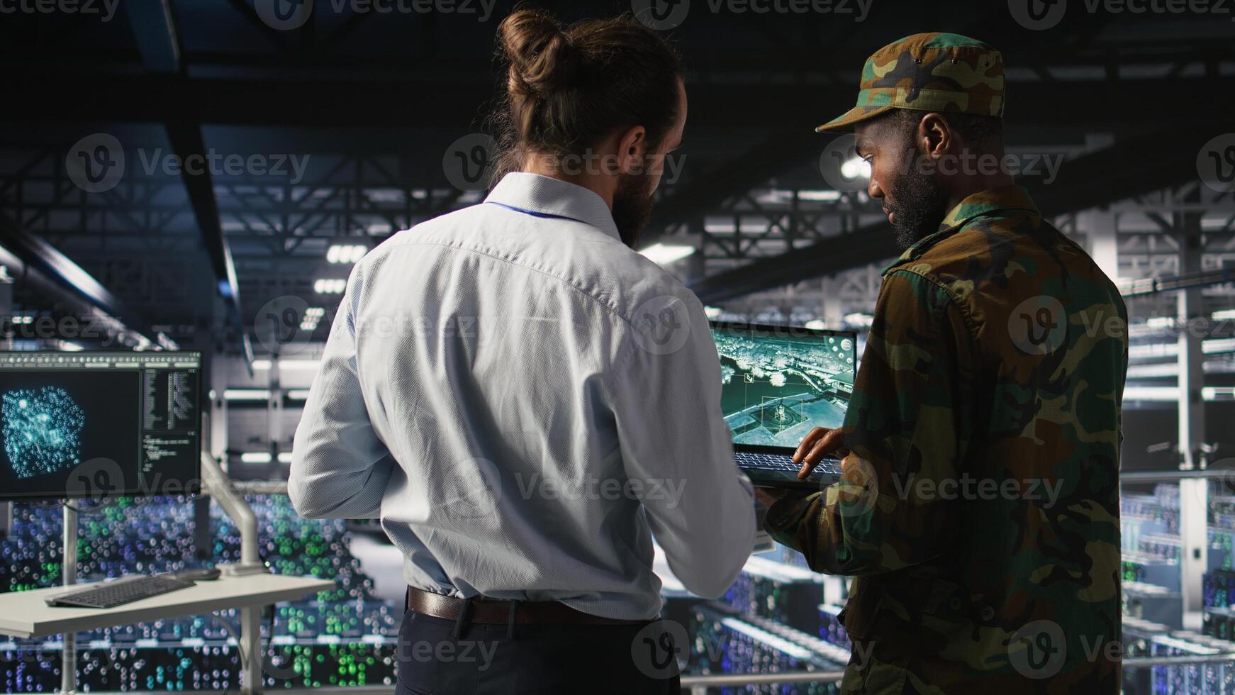 Army operators in data center using laptop to run drone control software, looking at mission map overlay. Military experts doing strategic deployment of autonomous aerial vehicles photo